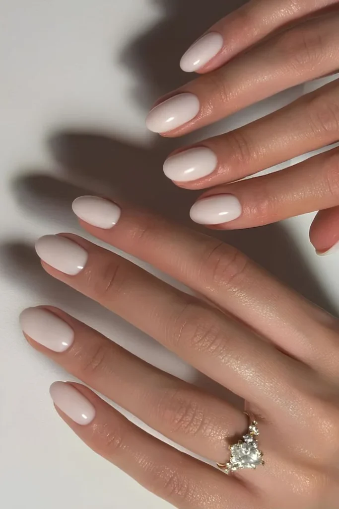 Elegant White Summer Nails in a soft, glossy almond shape, perfect for a chic and timeless summer manicure.