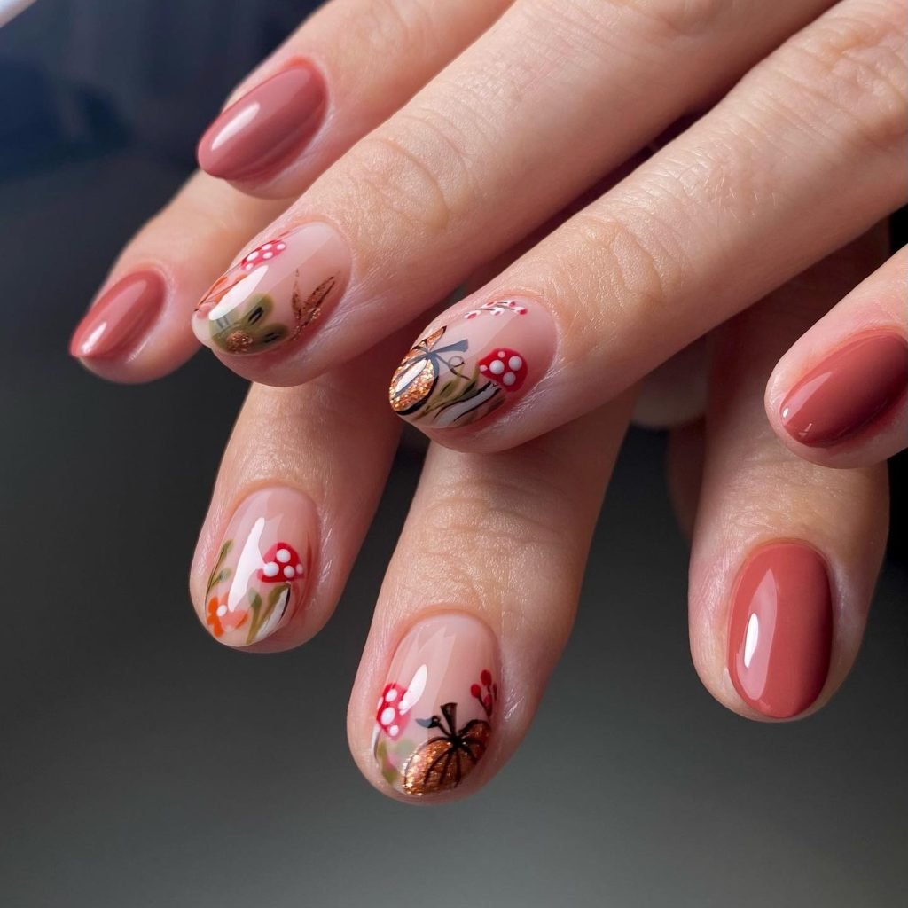 Short fall nail designs featuring autumn forest art with mushrooms, leaves, and warm earthy tones.