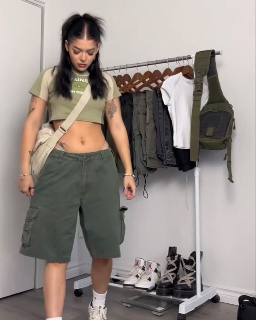 Edgy Cargo Shorts Outfit with oversized army green cargo shorts and a cropped olive tee, completed with sneakers and a crossbody bag for a streetwear aesthetic.