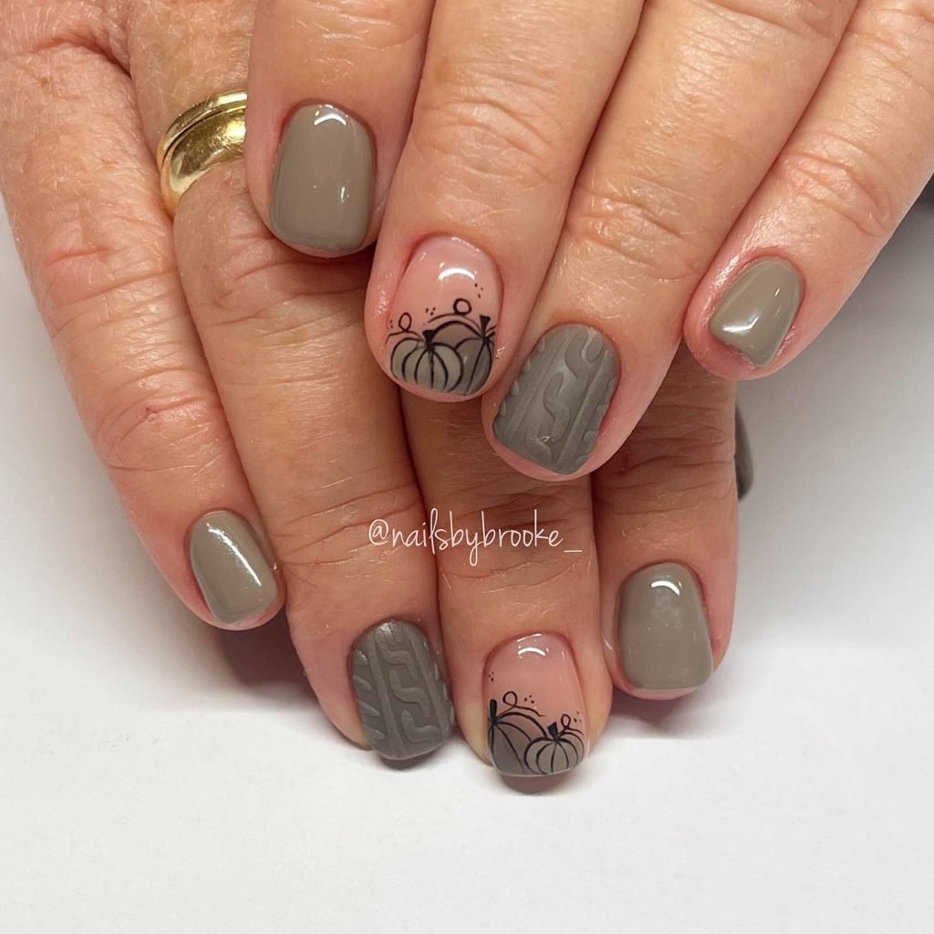 Short fall nail designs in taupe with black pumpkin outlines and cable-knit texture accent nails.