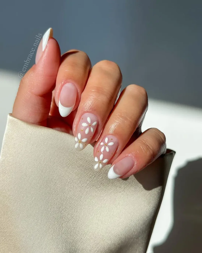 White Summer Nails with French tips and daisy flower accents, combining classic and playful summer elements.