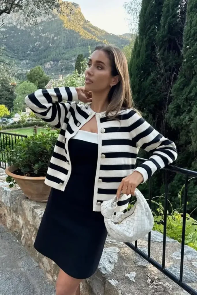Spring Outfit Ideas with a monochrome black and white palette, featuring a mini dress and striped cardigan, accessorized with a woven white bag.