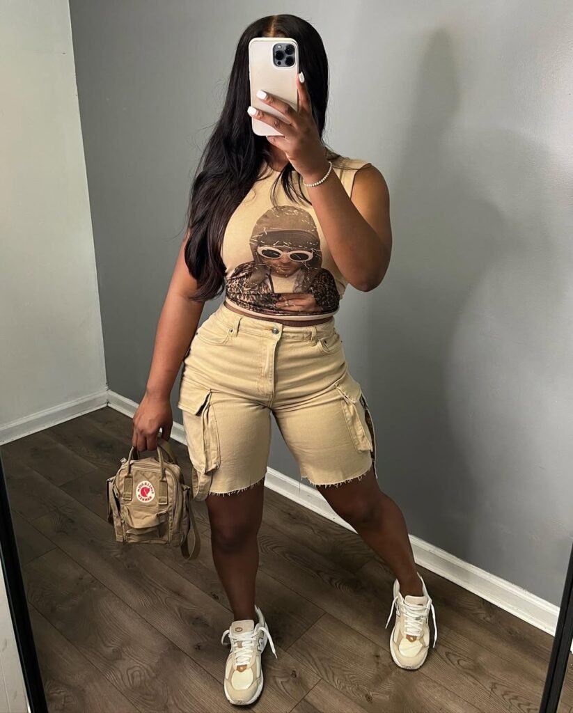 Sporty Cargo Shorts Outfit in khaki featuring a matching graphic crop top, beige cargo shorts, and chunky sneakers with a mini backpack.