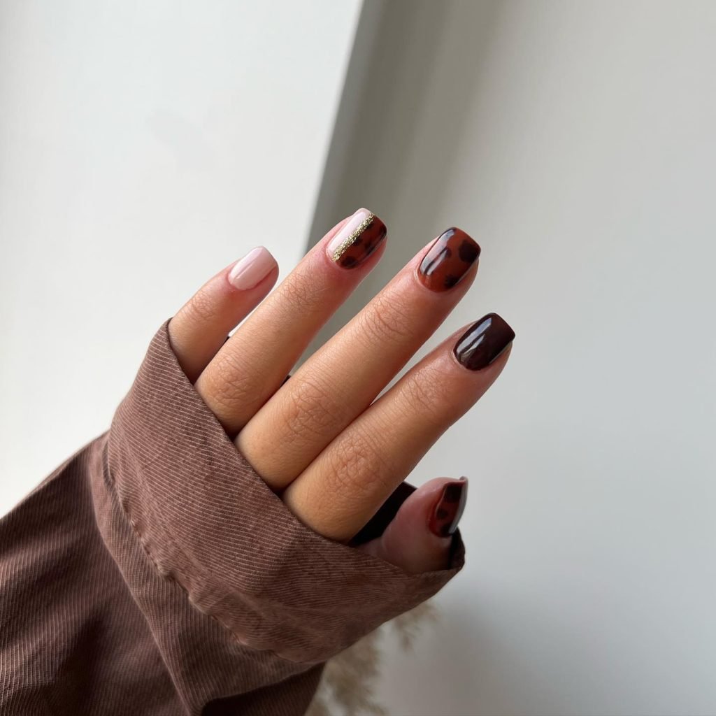 Short fall nail designs with tortoiseshell pattern, dark brown polish, and gold stripe accents.