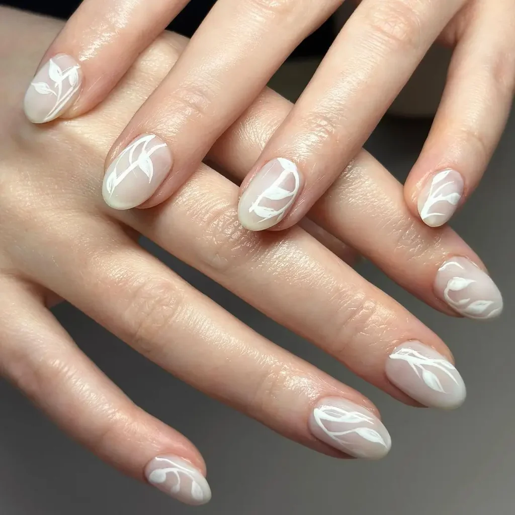 White Summer Nails featuring abstract white leaf line art over a nude base, offering a trendy and artistic summer touch.