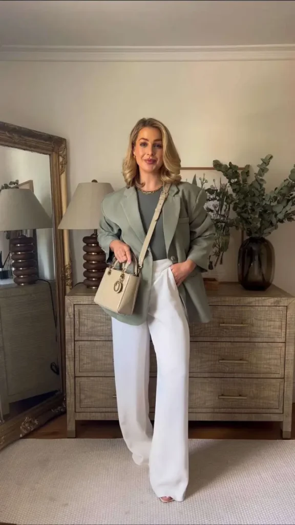 Structured green blazer, white trousers, and short blonde waves for a clean old money-inspired spring ensemble.