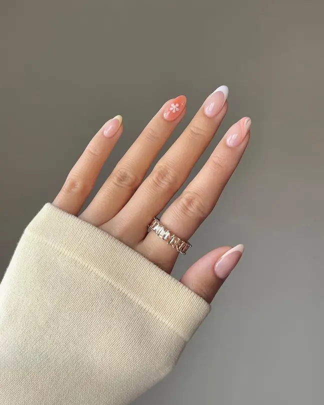 Delicate and feminine Stunning Nail Ideas with soft French tips and a dainty daisy design accent, perfect for a romantic minimal look.