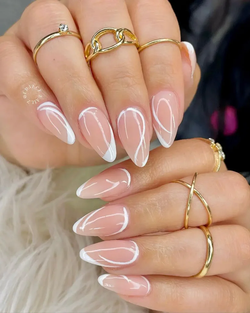 Creative White Summer Nails with pointed tips and white swirl patterns, adding a fun and modern summer twist.