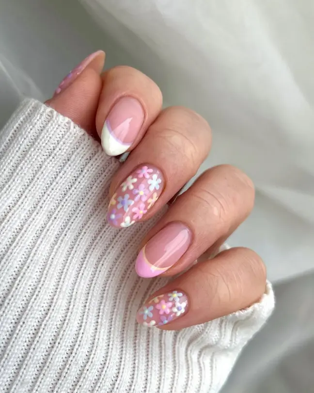 Whimsical Stunning Nail Ideas with pink-toned bases, pastel daisy prints, and curved accent tips—great for a playful spring manicure.