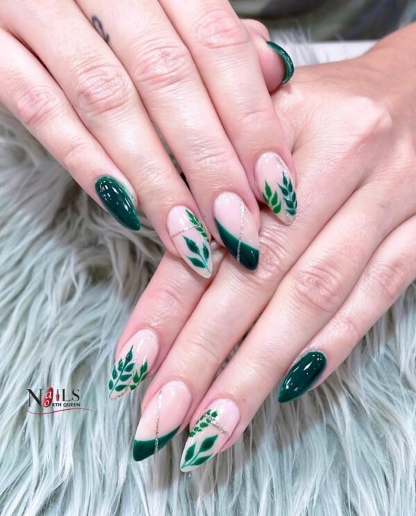 Green leafy nail almond design with glossy finish and silver accents.