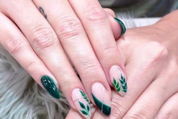 Green leafy nail almond design with glossy finish and silver accents.