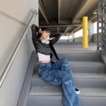 Edgy outfit inspo featuring a black mesh top, white crop tank, and oversized cargo jeans.