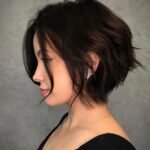 Side profile of a textured short bob with soft waves, perfect example of cute hairstyles for short hair.