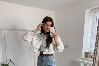 Light denim jeans and a cropped white jacket paired with white sneakers for a crisp everyday outfit. Outfits Casuales.