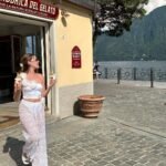Playful Summer Outfits with a unique white floral top and sheer lacy pants, captured while enjoying ice cream by the lake.