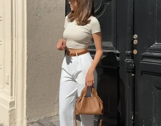 Modern Casual Summer Outfits featuring a fitted beige crop top with white high-waisted trousers, accessorized with sneakers and a tan handbag.
