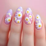 Lavender acrylic nails with 3D white daisies on an almond-shaped base for a playful garden look.
