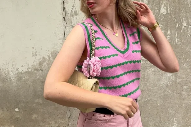 A cute simple outfit in soft pastels – pink striped sweater vest, pink high-waisted shorts, and a quilted cream handbag with floral accents, giving off sweet retro vibes.