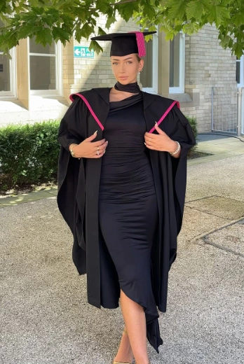 Graduation outfit ideas – ruched black midi dress styled with a matching black cap and gown featuring pink trim, paired with nude heels for a bold, chic aesthetic.
